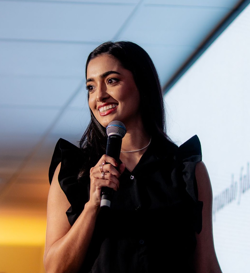 Nathana Gabriela speaking at an event with microphone